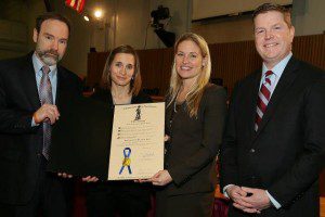 Joel Feldman (L), Emily Stein, the Governor's counsel and Tim Kelleher displaying the Governor's proclamation