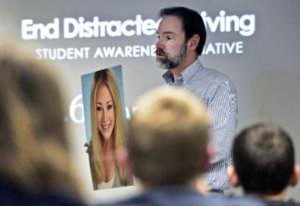 Joel Feldman holds a picture of his daughter, Casey, while he discusses the dangers of distracted driving during a driver education class at Longmont High School in CO (Greg Lindstrom/Times-Call