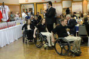 The Magee Eagles wheelchair rugby team is led in by Eagle Mike Mamula.