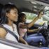 Young teenage driver seated in her new car